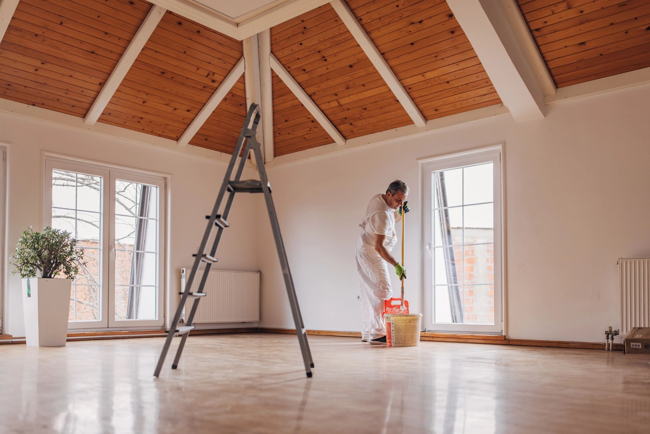 Painter applying finishing touches to house exterior
