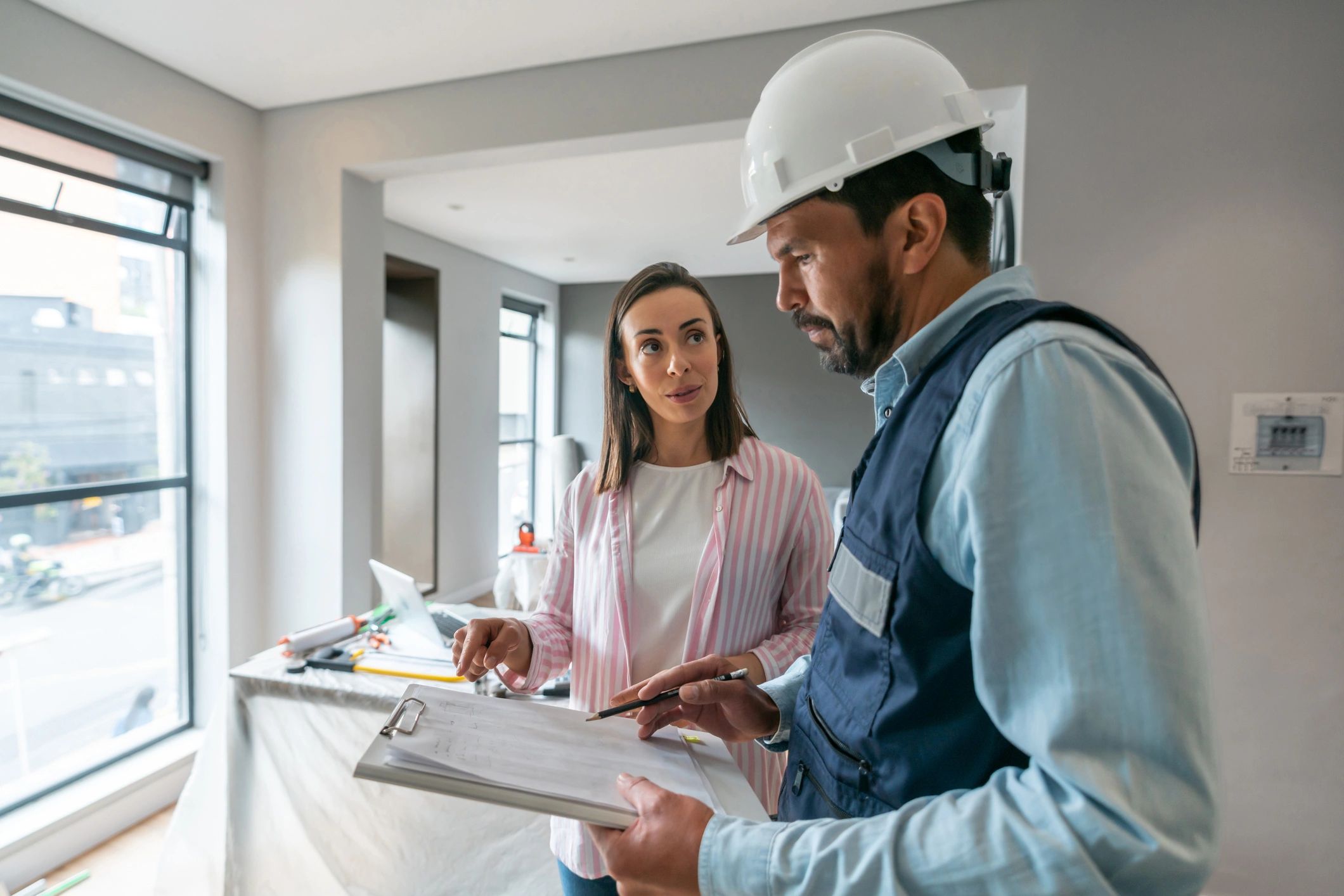 professional painter talking to homeowner